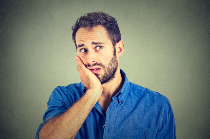No motivation in life. Sad worried man isolated on gray wall background <br />
krise-stress